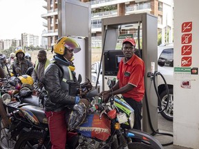 An attendant refuels a motorcycle taxi, also known as a 'boda boda', on the forecourt of a gas station in Nairobi, Kenya, on Wednesday, April 13, 2022. Kenya agreed to compensate oil marketers for selling fuel they imported at rates higher than what's reflected in the retail cap, a bid to end a supply shortage in the country.